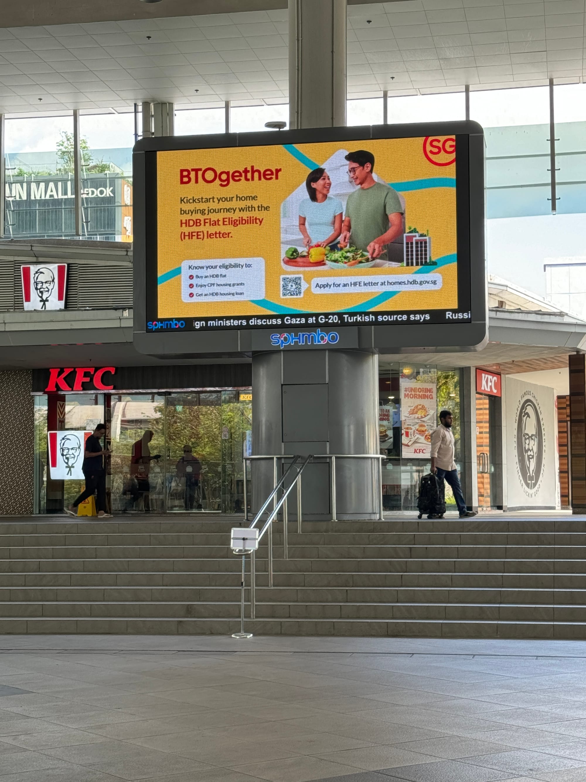 Image of billboard in a Singapore neighbourhood with the message "BTOgether: Kickstart your home buying journey with the HDB Flat Eligibility (HFE) Letter."